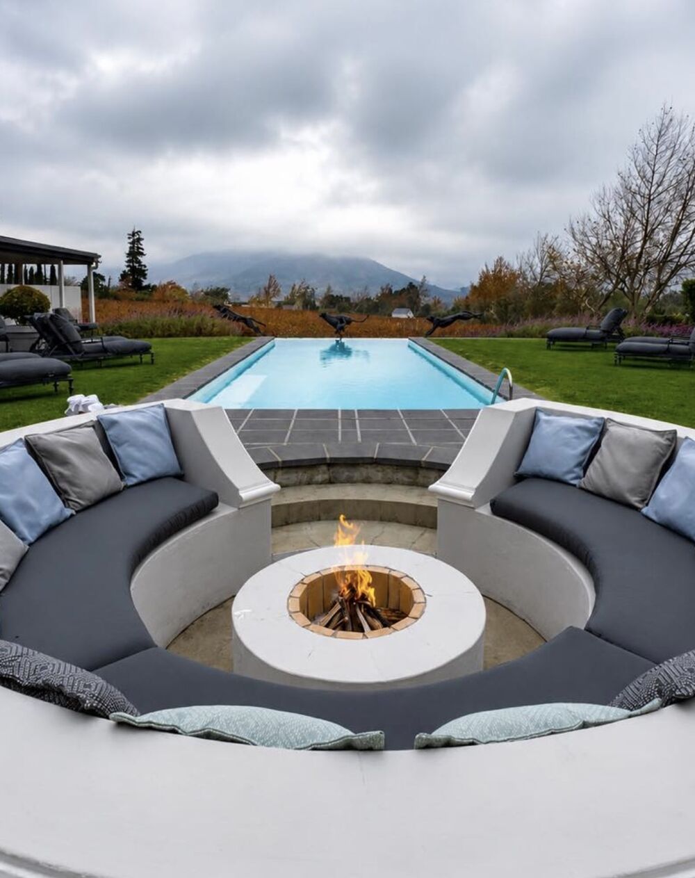 Sunken fire pit beside a lap pool in the Winelands