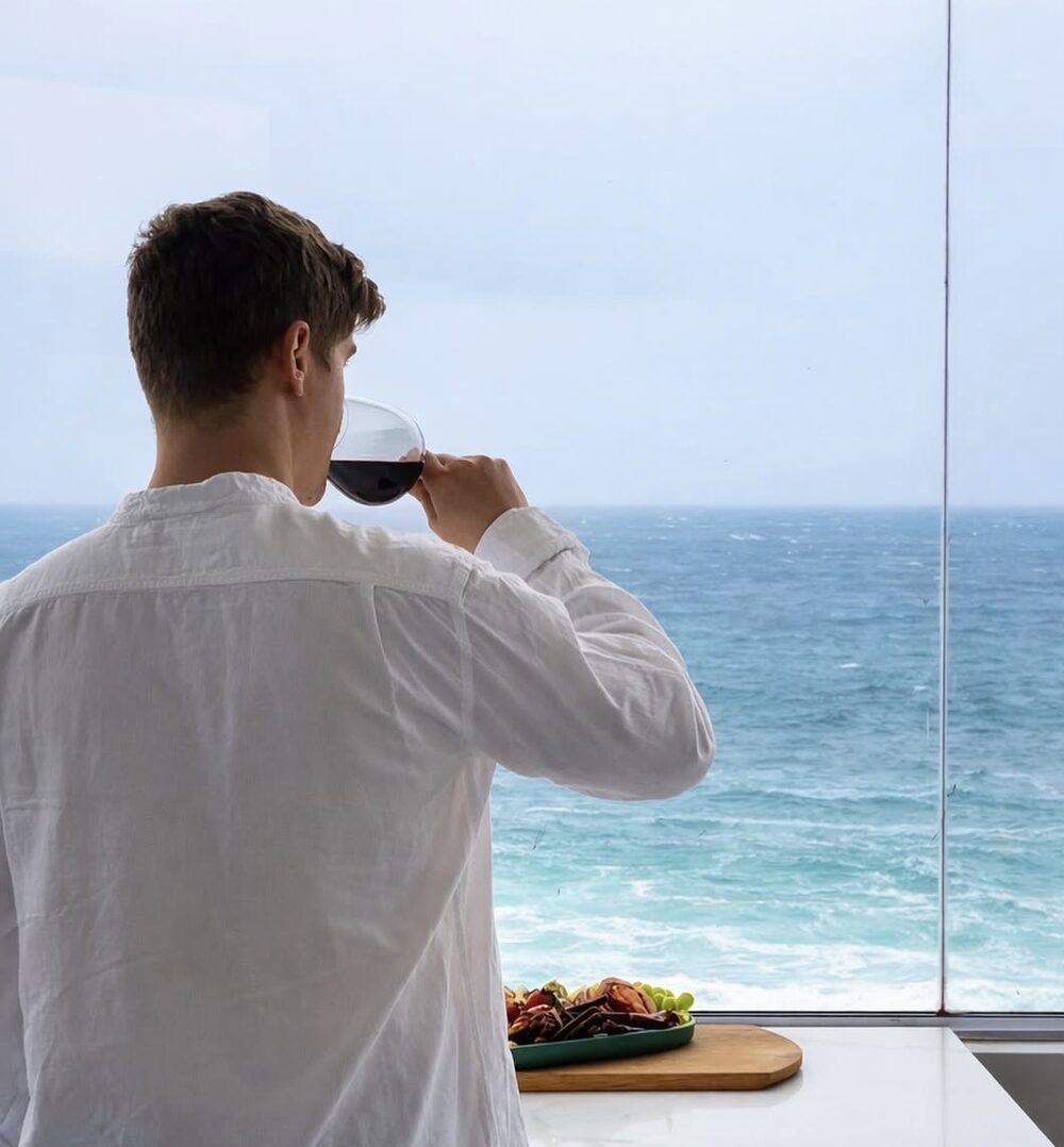 Nico Keyser enjoying a glass of wine with a sea view